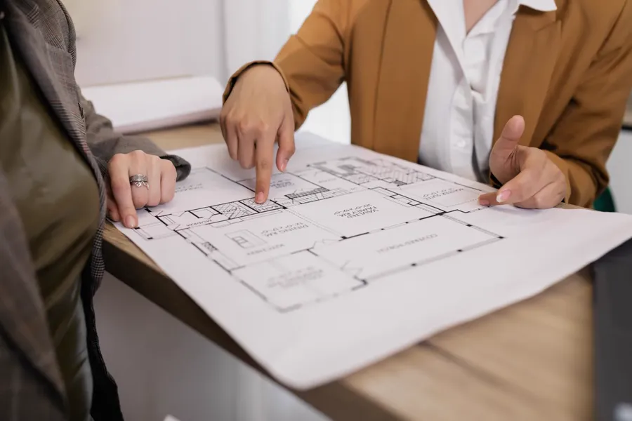 Consultants reviewing engineering drawings
